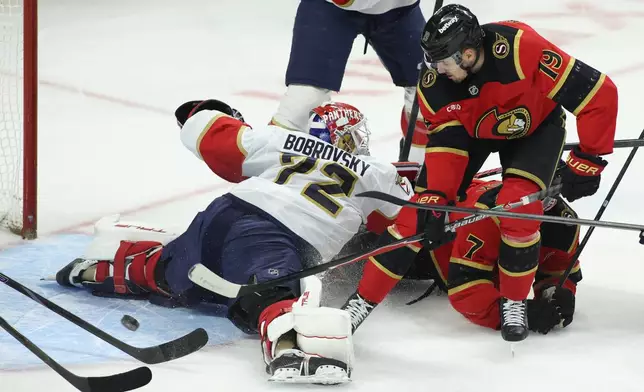 Ottawa Senators' Drake Batherson (19) tries to get the puck past Florida Panthers goaltender Sergei Bobrovsky (72) during the first period of an NHL hockey game in Ottawa on Saturday, Jan. 10, 2026. (Patrick Doyle/The Canadian Press via AP)