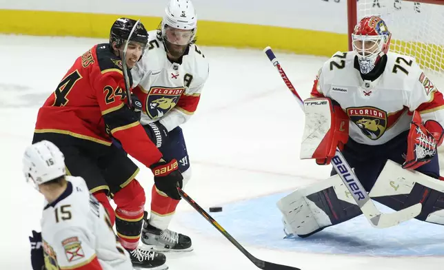 Ottawa Senators' Dylan Cozens (24) and Florida Panthers' Aaron Ekblad (5) battle for the puck in front of Panthers goaltender Sergei Bobrovsky (72) during second period NHL hockey action in Ottawa on Saturday, Jan. 10, 2026. (Patrick Doyle/The Canadian Press via AP)