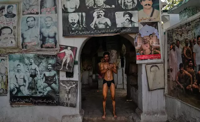 A young wrestler attends a training session in a wrestling academy in an old neighborhood of Lahore, Pakistan, Tuesday, Dec. 9, 2025. (AP Photo/K.M. Chaudary)