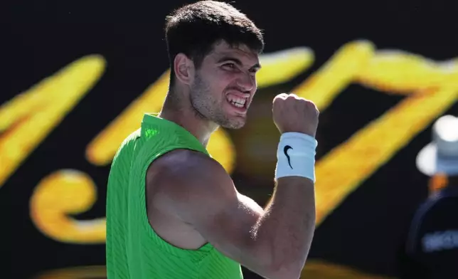 Carlos Alcaraz of Spain celebrates after defeating Yannick Hanfmann of Germany in their second round match at the Australian Open tennis championship in Melbourne, Australia, Wednesday, Jan. 21, 2026. (AP Photo/Dita Alangkara)