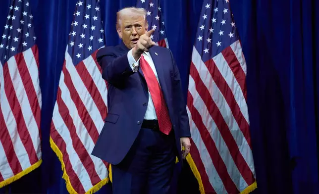 President Donald Trump points to the crowd as he walks off stage after speaking to House Republican lawmakers during their annual policy retreat, Tuesday, Jan. 6, 2026, in Washington. (AP Photo/Evan Vucci)