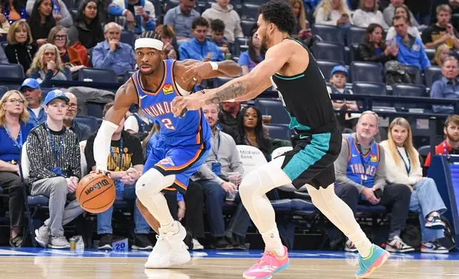Oklahoma City Thunder guard Shai Gilgeous-Alexander, left, drives past Portland Trail Blazers forward Toumani Camara during the second half of an NBA basketball game, Wednesday, Dec. 31, 2025, in Oklahoma City. (AP Photo/Kyle Phillips)