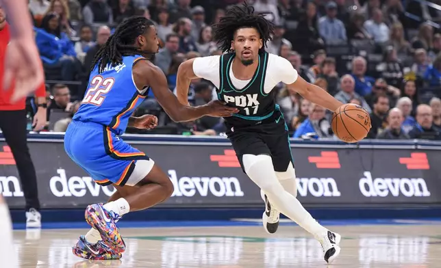 Portland Trail Blazers guard Shaedon Sharpe (17) pushes past Oklahoma City Thunder guard Cason Wallace (22) during the first half of an NBA basketball game, Wednesday, Dec. 31, 2025, in Oklahoma City. (AP Photo/Kyle Phillips)