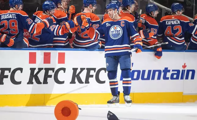 Edmonton Oilers' Connor McDavid (97) celebrates his hat trick goal against the Nashville Predators during the third period of an NHL game, in Edmonton, Tuesday, Jan. 6, 2026. (Jason Franson/The Canadian Press via AP)