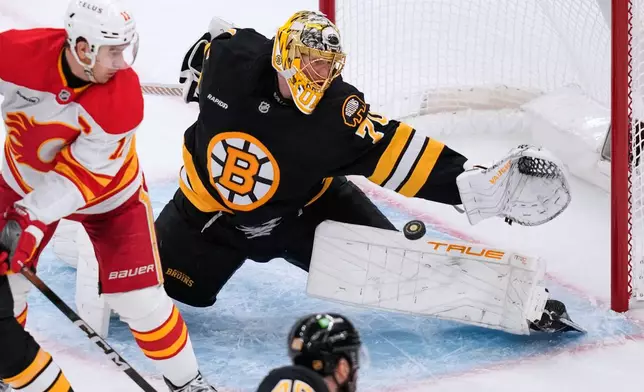 Boston Bruins goaltender Joonas Korpisalo (70) reaches for a save during the second period of an NHL hockey game against the Calgary Flames, Thursday, Jan. 8, 2026, in Boston. (AP Photo/Charles Krupa)