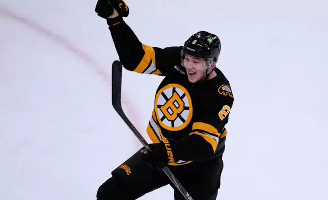 Boston Bruins defenseman Mason Lohrei celebrates after his goal against the Calgary Flames during the second period of an NHL hockey game, Thursday, Jan. 8, 2026, in Boston. (AP Photo/Charles Krupa)