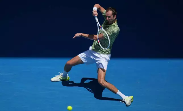 Daniil Medvedev of Russia plays a forehand return to Jesper de Jong of the Netherlands during their first round match at the Australian Open tennis championship in Melbourne, Australia, Monday, Jan. 19, 2026. (AP Photo/Dita Alangkara)