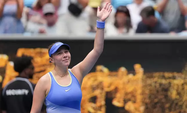 Amanda Anisimova of the U.S. waves after defeating Simona Waltert of Switzerland in their first round match at the Australian Open tennis championship in Melbourne, Australia, Monday, Jan. 19, 2026. (AP Photo/Dita Alangkara)