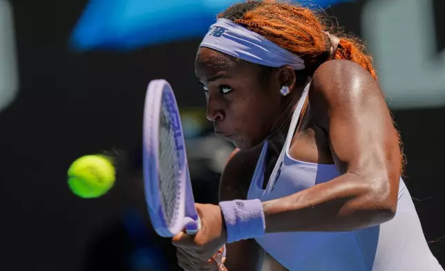 Coco Gauff of the U.S. plays a backhand return to Kamilla Rakhimova of Uzbekistan during their first round match at the Australian Open tennis championship in Melbourne, Australia, Monday, Jan. 19, 2026. (AP Photo/Aaron Favila)