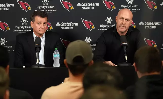 Arizona Cardinals owner Michael Bidwell and General Manager Monti Ossenfort acknowledge the media after firing head coach Jonathan Gannon Monday, Jan. 5, 2026, in Tempe, Ariz. (AP Photo/Rick Scuteri)