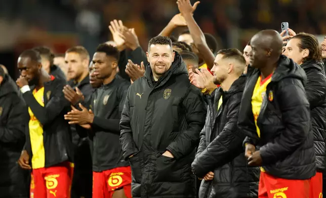 FILE - Lens' head coach Pierre Sage celebrates with players after the French League One soccer match between Lens and Marseille in Lens, France, Saturday, Oct. 25, 2025. (AP Photo/Jean-Francois Badias, File)