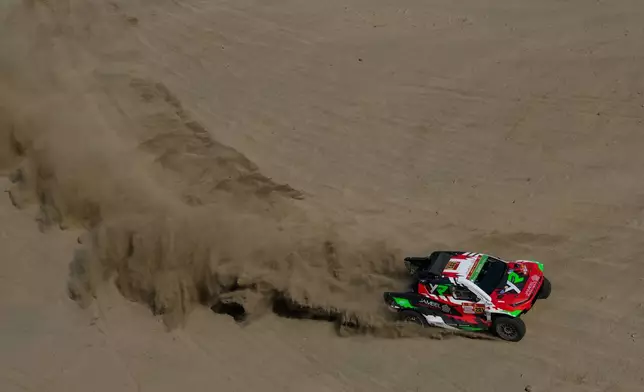 Driver Yawed Al Rahji and co-driver Timo Gottschalk compete during the first stage of the Dakar Rally in Yanbu, Saudi Arabia, Sunday, Jan. 4, 2026. (AP Photo/Thibault Camus)