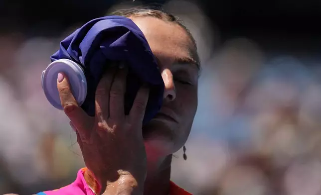 Aryna Sabalenka of Belarus places an ice pack to her face during their quarterfinal match against Iva Jovic of the U.S. at the Australian Open tennis championship in Melbourne, Australia, Tuesday, Jan. 27, 2026. (AP Photo/Dita Alangkara)