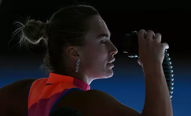 Aryna Sabalenka of Belarus blows cold air onto her face during her quarterfinal match against Iva Jovic of the U.S. at the Australian Open tennis championship in Melbourne, Australia, Tuesday, Jan. 27, 2026. (AP Photo/Dita Alangkara)