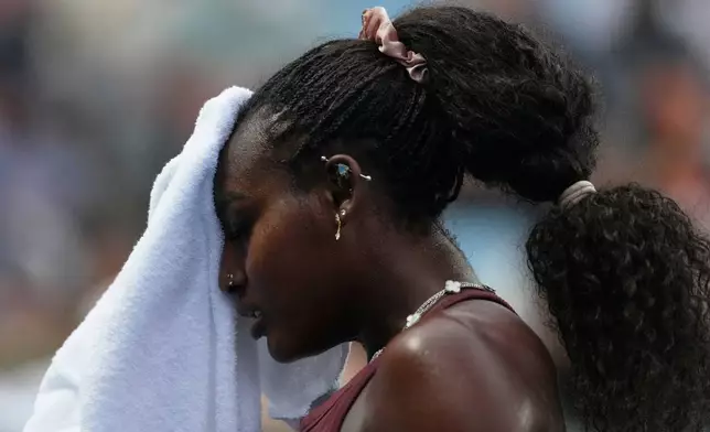 Alycia Parks of the U.S. wipes the sweat from her face during her second round match against Karolina Muchova of the Czech Republic at the Australian Open tennis championship in Melbourne, Australia, Wednesday, Jan. 21, 2026. (AP Photo/Asanka Brendon Ratnayake)