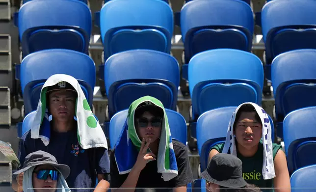 Spectators watch third round matches at the Australian Open tennis championship in Melbourne, Australia, Saturday, Jan. 24, 2026. (AP Photo/Dar Yasin)