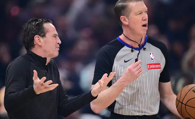 Cleveland Cavaliers head coach Kenny Atkinson, left, disputes a call with referee Ed Malloy, right, in the first half of an NBA basketball game against the Oklahoma City Thunder, Monday, Jan. 19, 2026, in Cleveland. (AP Photo/David Dermer)