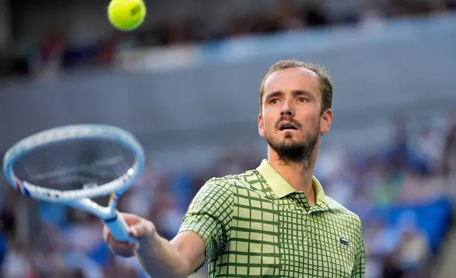 Daniil Medvedev of Russia plays prepares to serve to Learner Tien of the U.S. during their fourth round match at the Australian Open tennis championship in Melbourne, Australia, Sunday, Jan. 25, 2026. (AP Photo/Asanka Brendon Ratnayake)