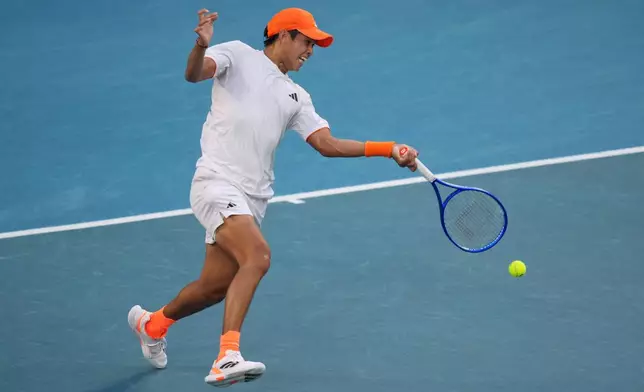 Learner Tien of the U.S. plays a forehand return to Daniil Medvedev of Russia during their fourth round match at the Australian Open tennis championship in Melbourne, Australia, Sunday, Jan. 25, 2026. (AP Photo/Asanka Brendon Ratnayake)