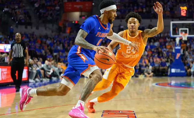 Florida guard Boogie Fland (0) drives during the second half of an NCAA college basketball game against Tennessee, Saturday, Jan. 10, 2026, in Gainesville, Fla. (AP Photo/Noah Lantor)