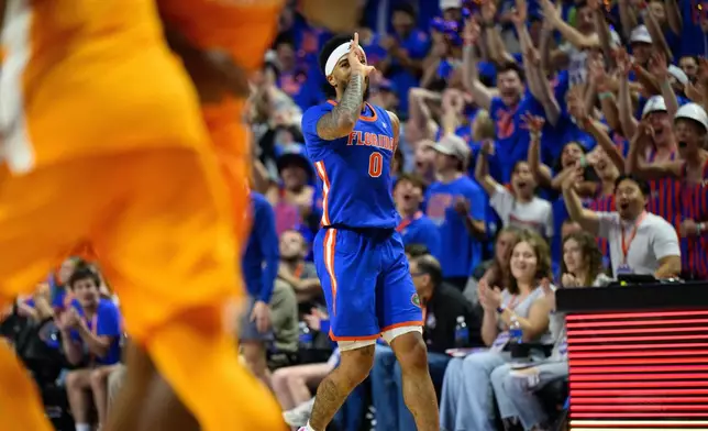 Florida guard Boogie Fland (0) celebrates a three point shot during the second half of an NCAA college basketball game against Tennessee, Saturday, Jan. 10, 2026, in Gainesville, Fla. (AP Photo/Noah Lantor)