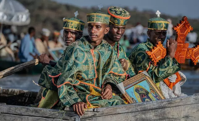 High priests ride in a boat as faithful celebrate Timket, the Ethiopian Epiphany, on lake Dembel, in Batu, Ethiopia, Sunday, Jan. 18, 2026. (AP Photo/Amanuel Sileshi)
