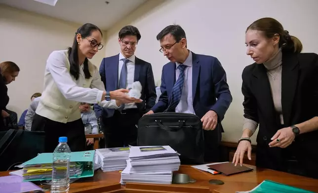 Participants gather in Moscow's Arbitration Court to hold a hearing to consider a lawsuit by Russia's Central Bank against Belgium-based financial clearinghouse Euroclear in Moscow, Russia, Friday, Jan. 16, 2026. (AP Photo/Pavel Bednyakov)