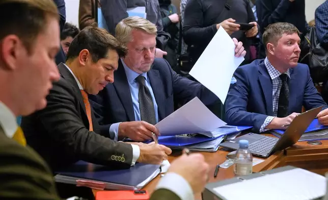 Participants gather in Moscow's Arbitration Court to hold a hearing to consider a lawsuit by Russia's Central Bank against Belgium-based financial clearinghouse Euroclear in Moscow, Russia, Friday, Jan. 16, 2026. (AP Photo/Pavel Bednyakov)