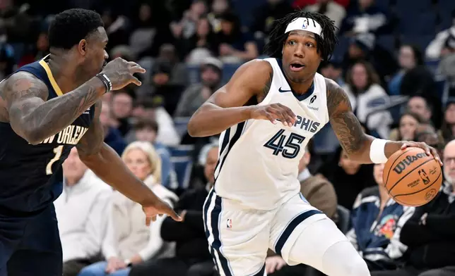 Memphis Grizzlies forward GG Jackson II (45) handles the ball against New Orleans Pelicans forward Zion Williamson (1) in the first half of an NBA basketball game Friday, Jan. 23, 2026, in Memphis, Tenn. (AP Photo/Brandon Dill)