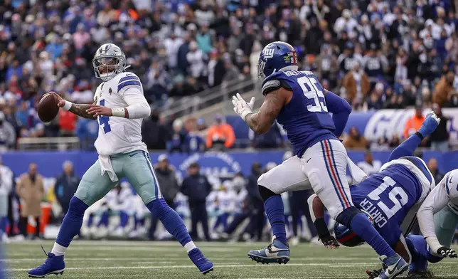 Dallas Cowboys quarterback Dak Prescott (4) passes under pressure against the New York Giants during the second quarter of an NFL football game, Sunday, Jan. 4, 2026, in East Rutherford, N.J. (AP Photo/Adam Hunger)
