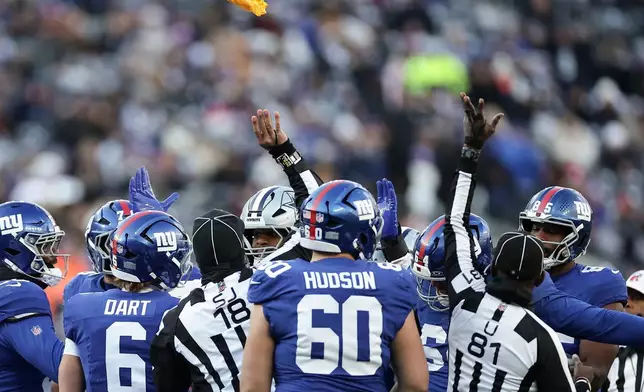 Officials through flags during an altercation on the field between the New York Giants and the Dallas Cowboys during the third quarter of an NFL football game, Sunday, Jan. 4, 2026, in East Rutherford, N.J. (AP Photo/Adam Hunger)