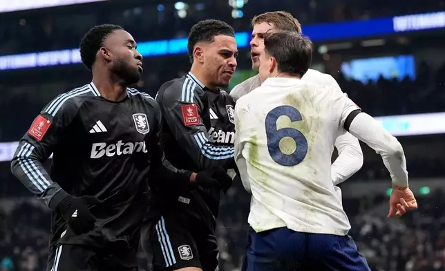 Aston Villa's Morgan Rogers, second left, and Tottenham Hotspur's Joao Palhinha, right, clash after the FA Cup third round soccer match between Tottenham Hotspur and Aston Villa in London, Saturday Jan. 10, 2026. (Andrew Matthews/PA via AP)