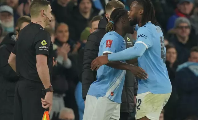 Manchester City's Jeremy Doku substitutes Antoine Semenyo during the FA Cup third round match between Manchetster City and Exeter City in Manchester, England Saturday, Jan. 10, 2026. (AP Photo/Ian Hodgson)