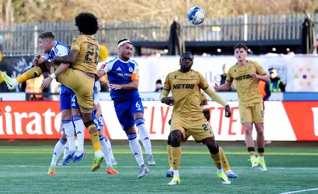 Macclesfield Town's Paul Dawson scores the opening goal, during the FA Cup third round soccer match between Macclesfield Town and Crystal Palace, at the Leasing.com Stadium, Macclesfield, England, Saturday, Jan. 10, 2026. (Martin Rickett/PA via AP)