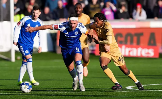 Crystal Palace's Kaden Rodney, center right, and Macclesfield Town's Paul Dawson vie for the ball, during the FA Cup third round soccer match between Macclesfield Town and Crystal Palace, at the Leasing.com Stadium, Macclesfield, Saturday, Jan. 10, 2026. (Martin Rickett/PA via AP)