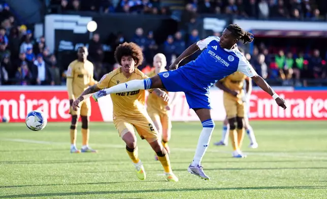 Macclesfield Town's Isaac Buckley-Ricketts scores his side's second goal during the FA Cup third round soccer match between Macclesfield Town and Crystal Palace, at the Leasing.com Stadium, Macclesfield, England, Saturday, Jan. 10, 2026. (Martin Rickett/PA via AP)