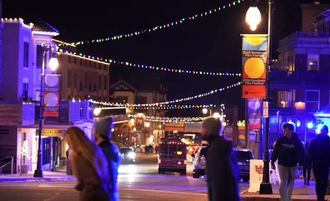 Pedestrians pass down Main Street before the start of the 2026 Sundance Film Festival on Wednesday, Jan. 21, 2026, in Park City, Utah. (AP Photo/Chris Pizzello)