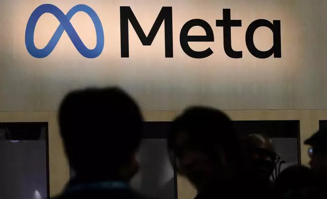 FILE - Attendees visit the Meta booth at the Game Developers Conference 2023 in San Francisco on March 22, 2023. (AP Photo/Jeff Chiu, File)