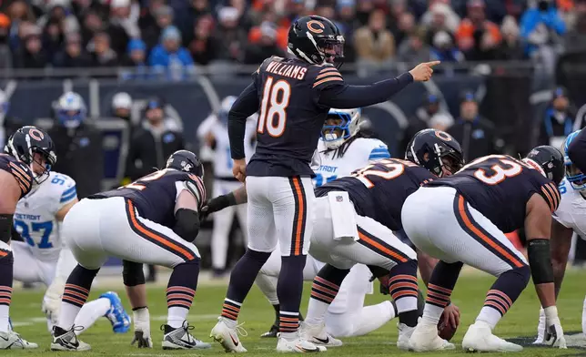 Chicago Bears quarterback Caleb Williams (18) directs teammates during the first half of an NFL football game against the Detroit Lions, Sunday, Jan. 4, 2026, in Chicago. (AP Photo/Nam Y. Huh)