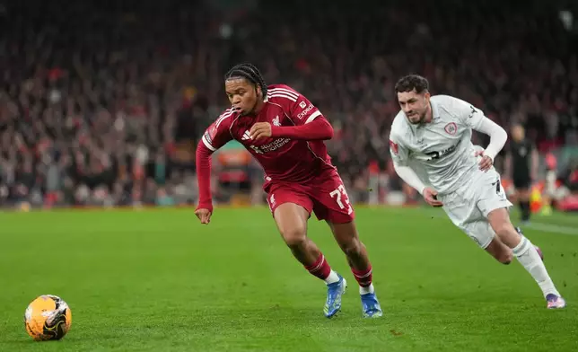 Barnsley's Corey O'Keeffe, left, and -mu73- fight for the ball during the FA Cup third round soccer match between Liverpool and Barnsley in Liverpool, England, Monday, Jan. 12, 2026. (AP Photo/Jon Super)