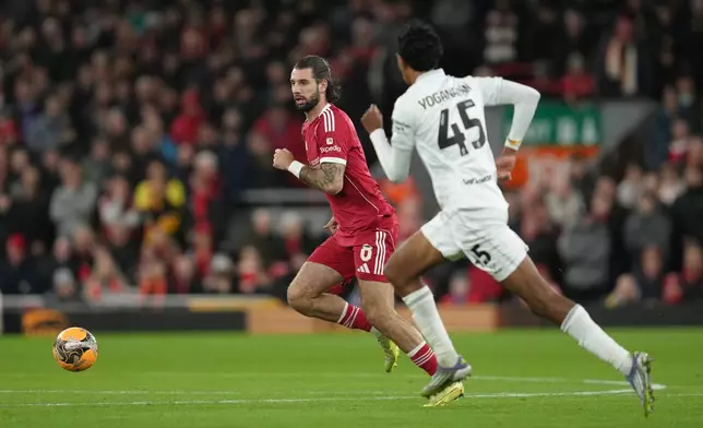 Barnsley's Vimal Yoganathan guards Liverpool's Dominik Szoboszlai during the FA Cup third round soccer match between Liverpool and Barnsley in Liverpool, England, Monday, Jan. 12, 2026. (AP Photo/Jon Super)