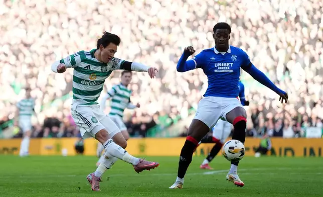 Celtic's Yang Hyun-Jun scores his side's first goal of the game, during the Scottish Premiership soccer match between Celtic and Rangers in Glasgow, Scotland, Saturday, Jan. 3, 2026. (Andrew Milligan/PA via AP)