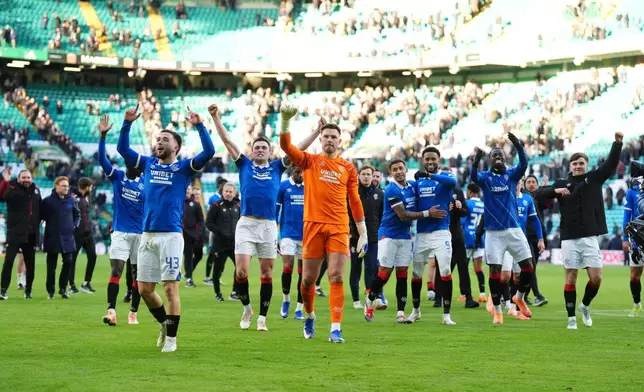 Rangers players celebrate after the Scottish Premiership soccer match between Celtic and Rangers in Glasgow, Scotland, Saturday, Jan. 3, 2026. (Andrew Milligan/PA via AP)