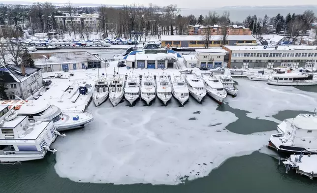 Ice builds up at a pier of Lake Balaton at Siofok, Hungary, Wednesday, Jan. 7, 2026. (Tamas Vasvari/MTI via AP)/MTI via AP)