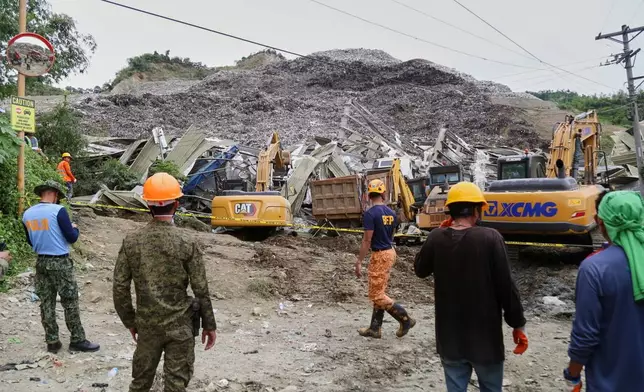 Search and rescue operation continues after a huge mound of garbage collapsed at a waste segregation facility in Binaliw, Cebu city on Friday, Jan. 9, 2026. (AP Photo/Jacqueline Hernandez)