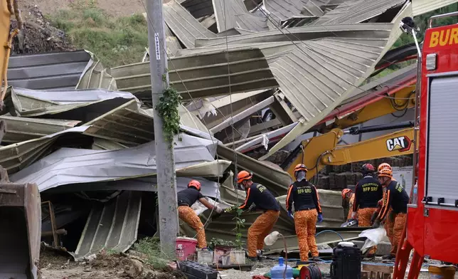 Search and rescue operation continues after a huge mound of garbage collapsed at a waste segregation facility in Binaliw, Cebu city on Friday, Jan. 9, 2026. (AP Photo/Jacqueline Hernandez)
