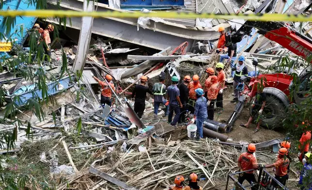 Rescuers continue operations on a collapsed waste segregation facility in Binaliw, Cebu city, central Philippines on Saturday, Jan. 10, 2026. (AP Photo/Jacqueline Hernandez)