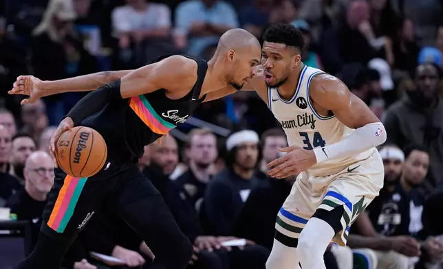 San Antonio Spurs forward Victor Wembanyama, left, drives against Milwaukee Bucks forward Giannis Antetokounmpo (34) during the second half of an NBA basketball game in San Antonio, Thursday, Jan. 15, 2026. (AP Photo/Eric Gay)