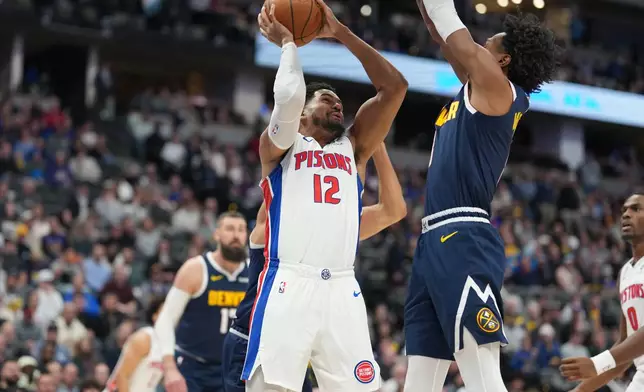Detroit Pistons forward Tobias Harris, left, goes up for a basket as Denver Nuggets guard Peyton Watson defends in the first half of an NBA basketball game, Tuesday, Jan. 27, 2026, in Denver. (AP Photo/David Zalubowski)