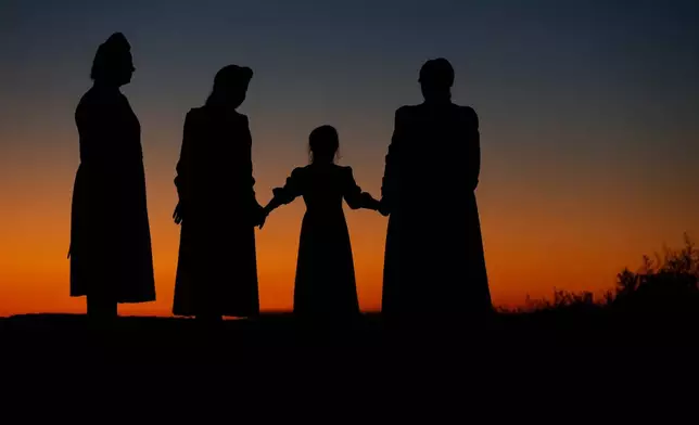 FILE - From left, Esther Bistline, Angie Bistline, Lydia Ann Richter and Norma Richter gather to pose for photographs in Colorado City, Ariz., on Wednesday, Oct. 25, 2017. (AP Photo/Rick Bowmer, File)